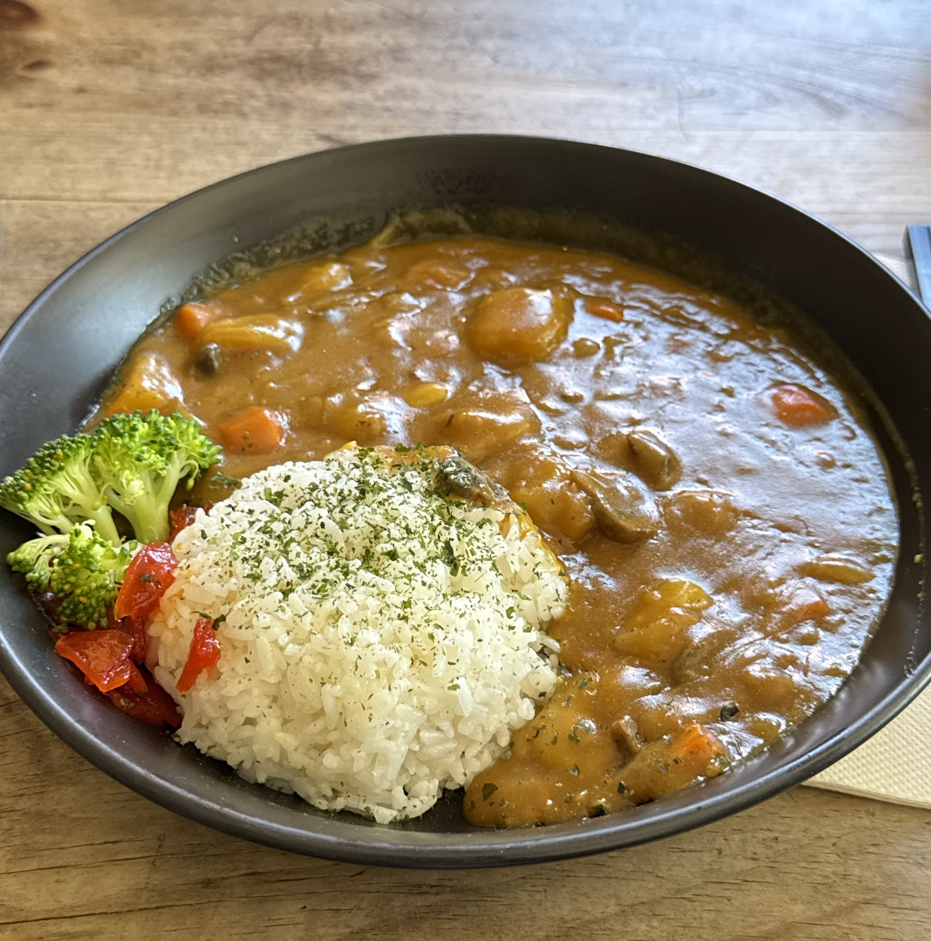 Bowl of Japanese curry with white rice, broccoli and vegetables